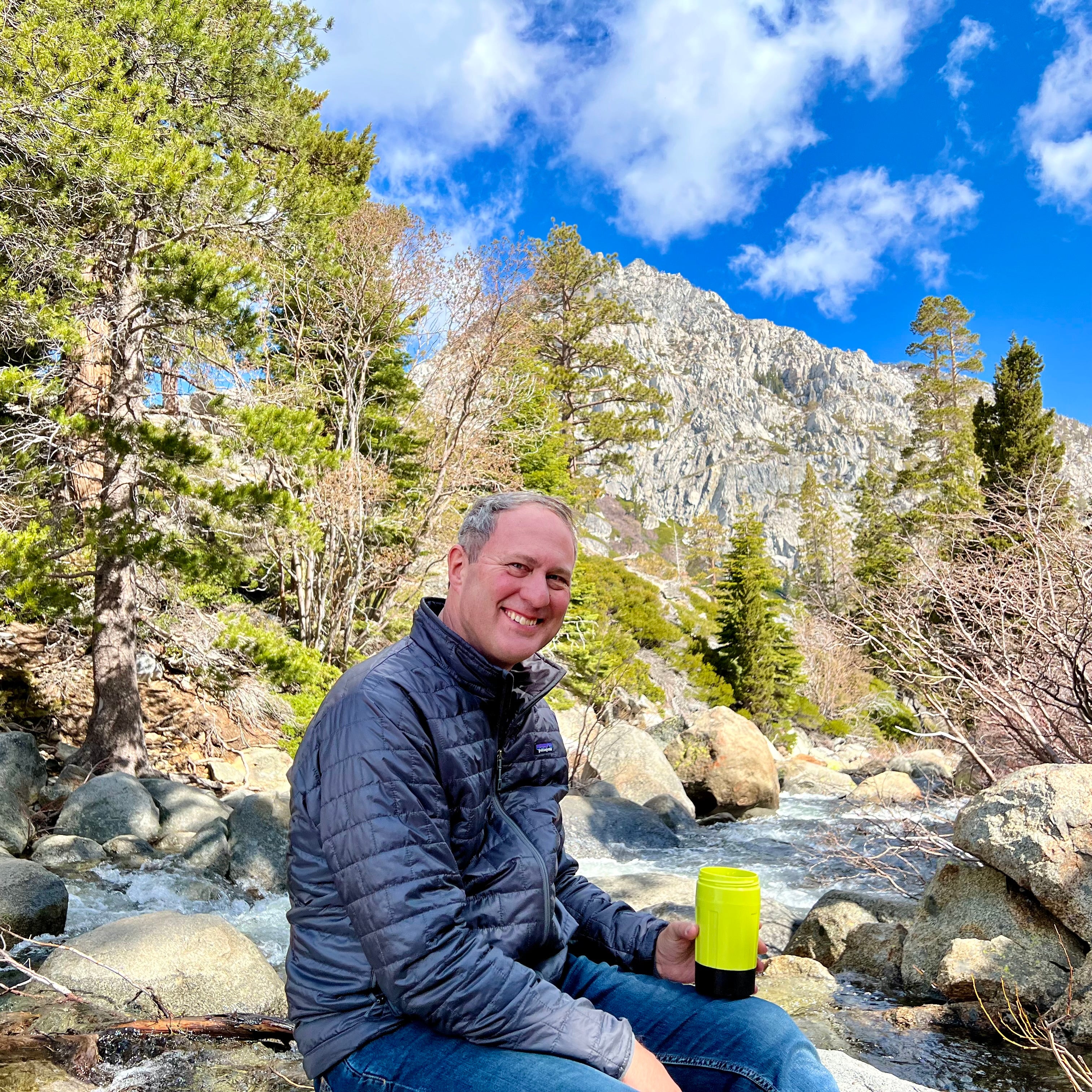 Bill Swift, co-founder of EcoSimmer, holding EcoSimmer Electric Backpacking Stove