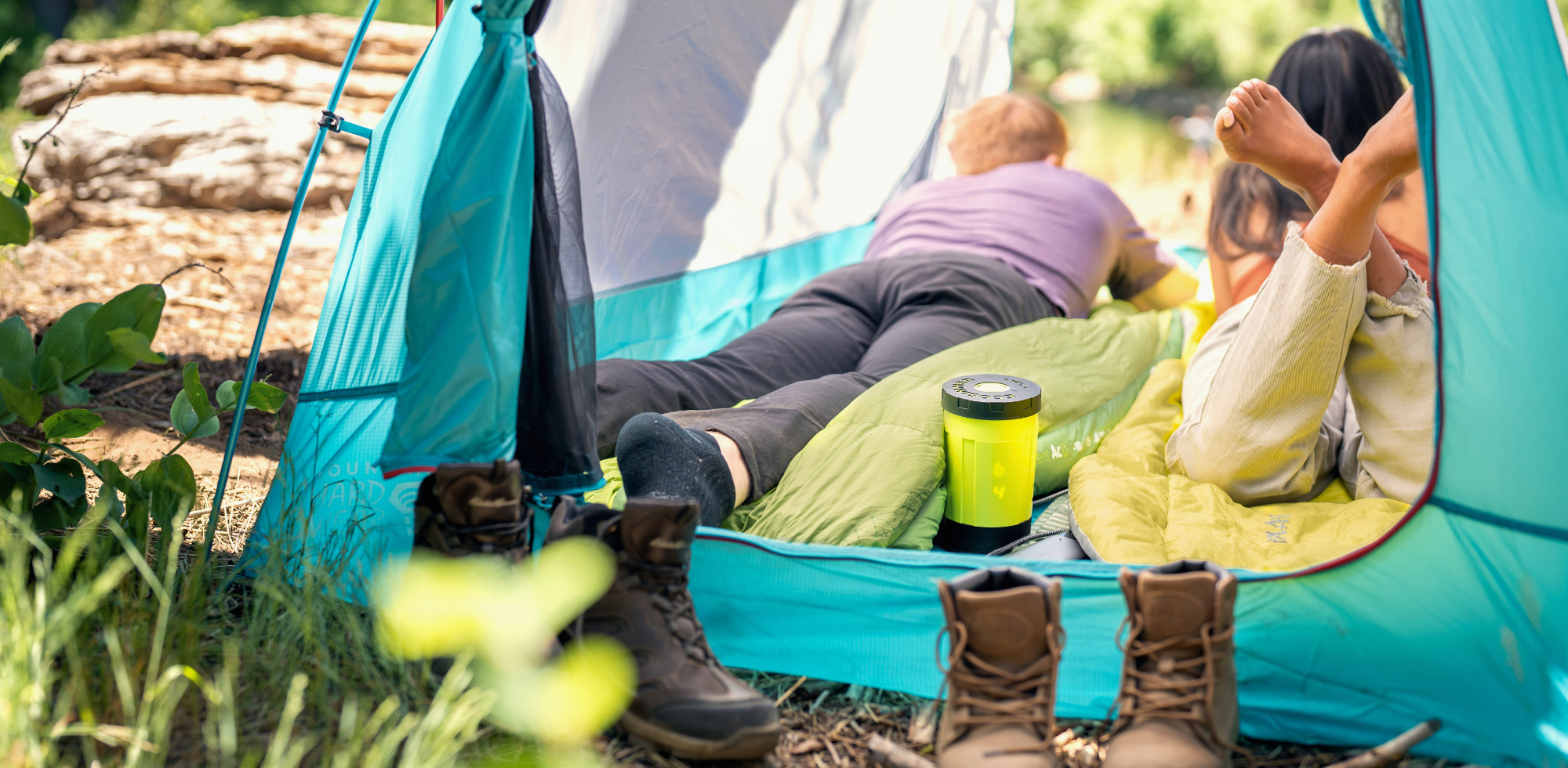 Couple relaxing in tent while cooking with EcoSimmer USB-C electric backpacking stove