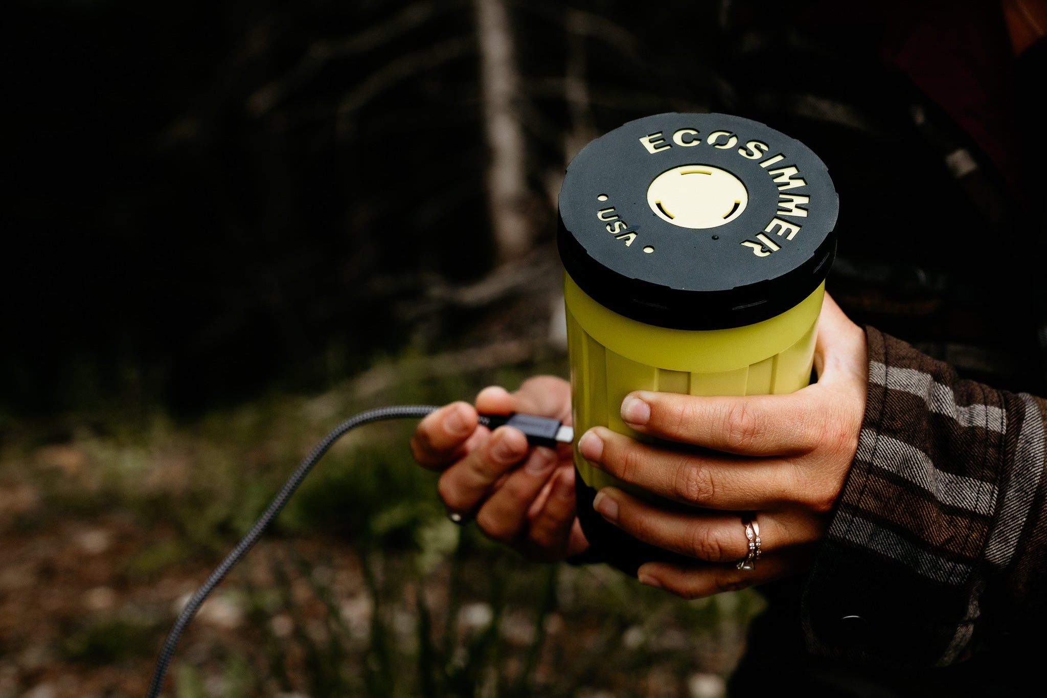 Woman plugs electric camping stove into battery with USB-C cable